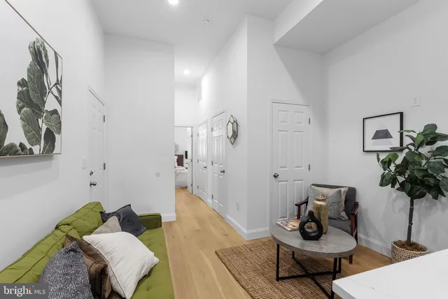 a living room with furniture and wooden floor