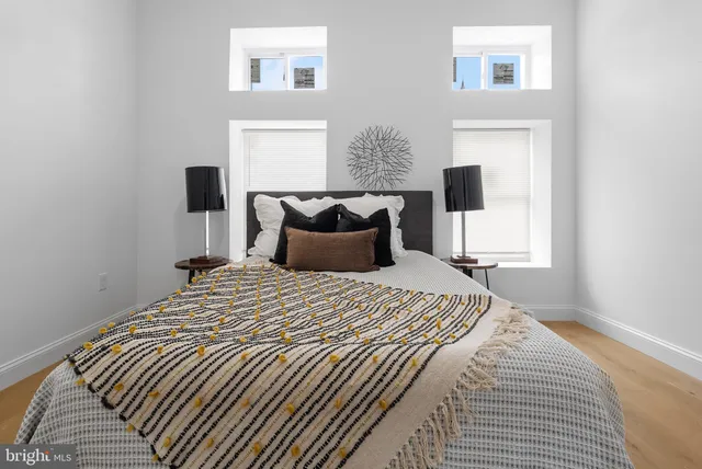 a bedroom with a bed and a night stand