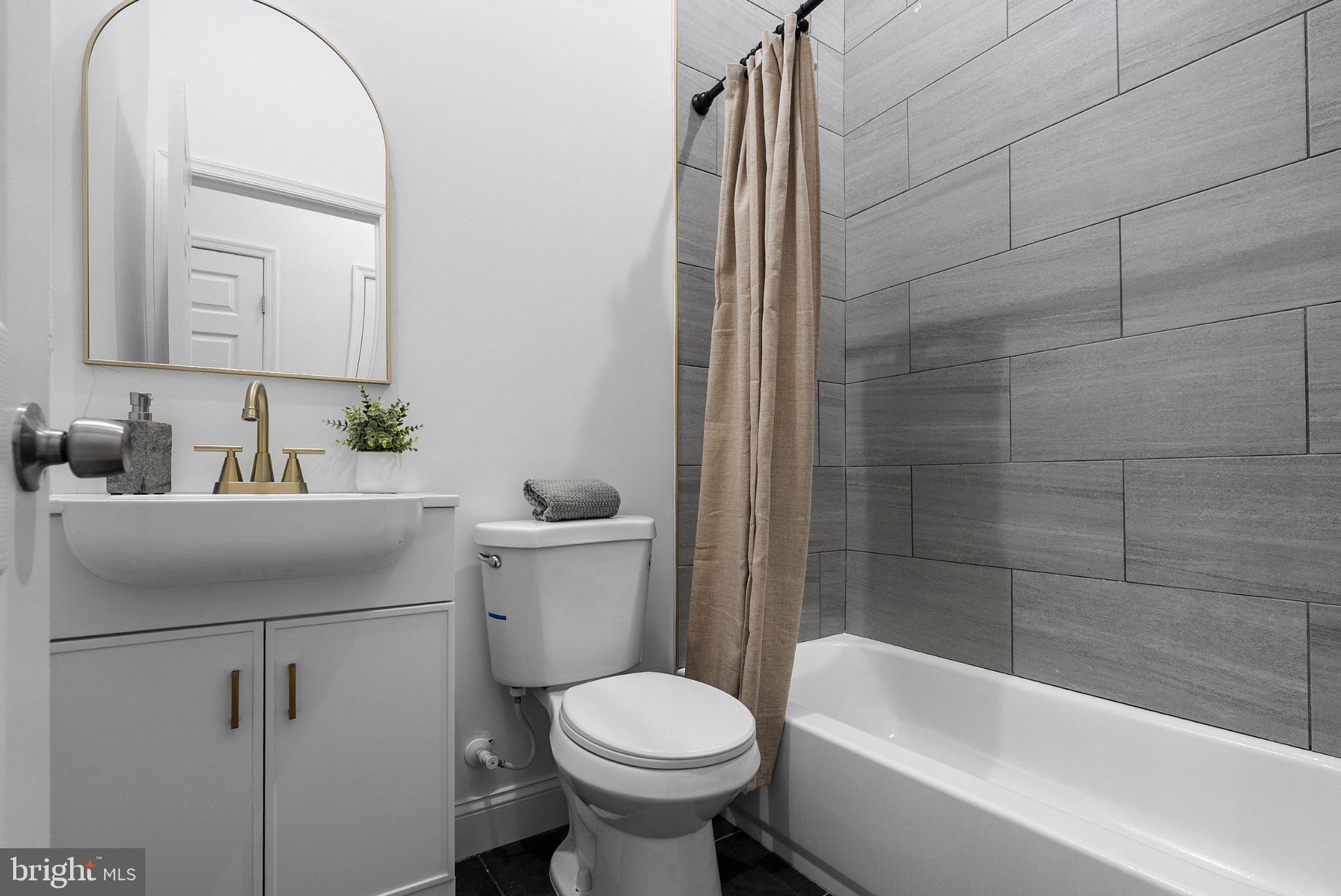 2106 McCulloh Street Baltimore, MD 21217 - Photo 9 of 38 a bathroom with a sink toilet and shower