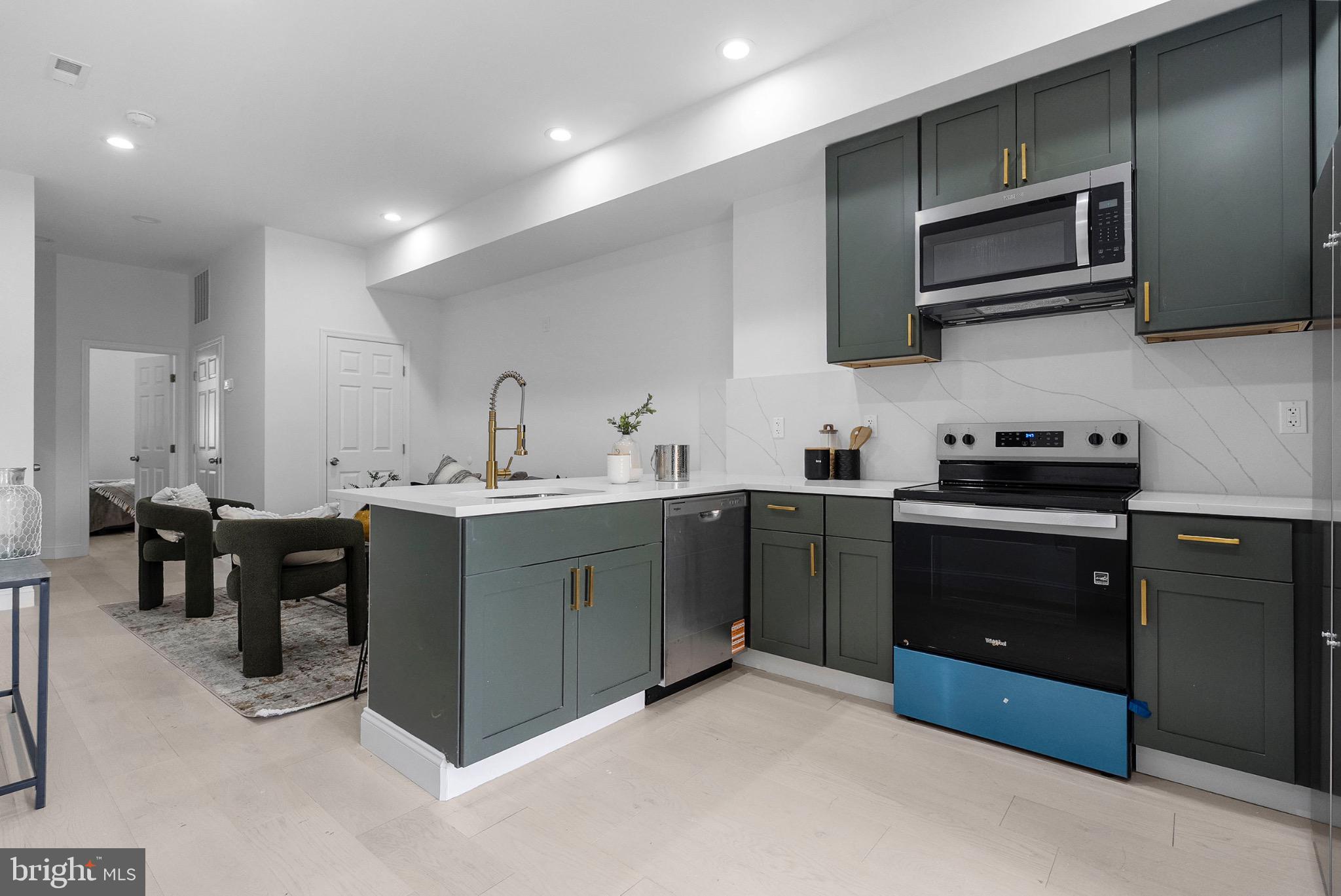 2106 McCulloh Street Baltimore, MD 21217 - Photo 10 of 38 a kitchen with stainless steel appliances granite countertop a sink and stove top oven