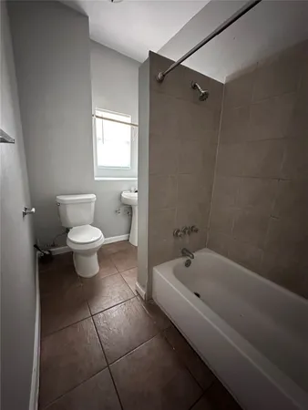 a bathroom with a toilet and a bathtub