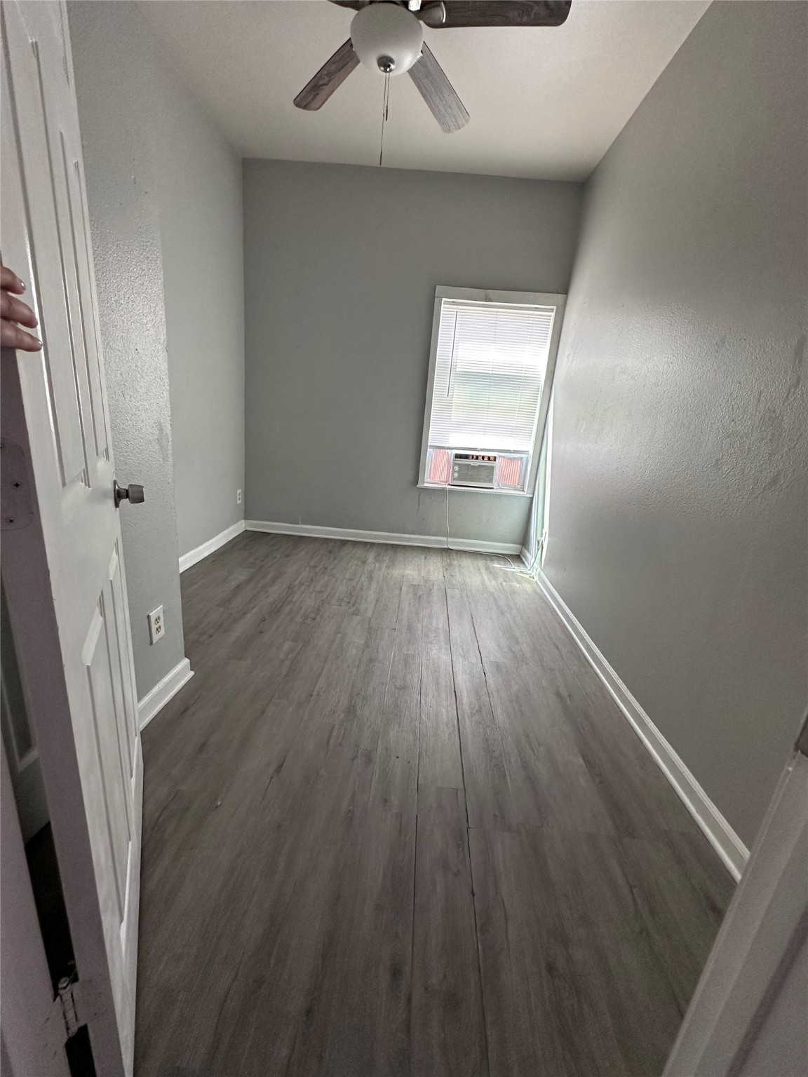 910 37th Street, Unit 3 Galveston, TX 77550 - Photo 15 of 18 wooden floor in an empty room with a window