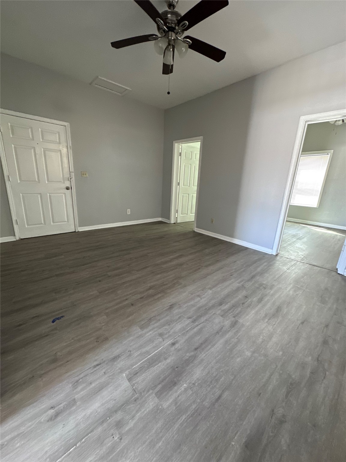 910 37th Street, Unit 3 Galveston, TX 77550 - Photo 3 of 18 an empty room with wooden floor fan and windows