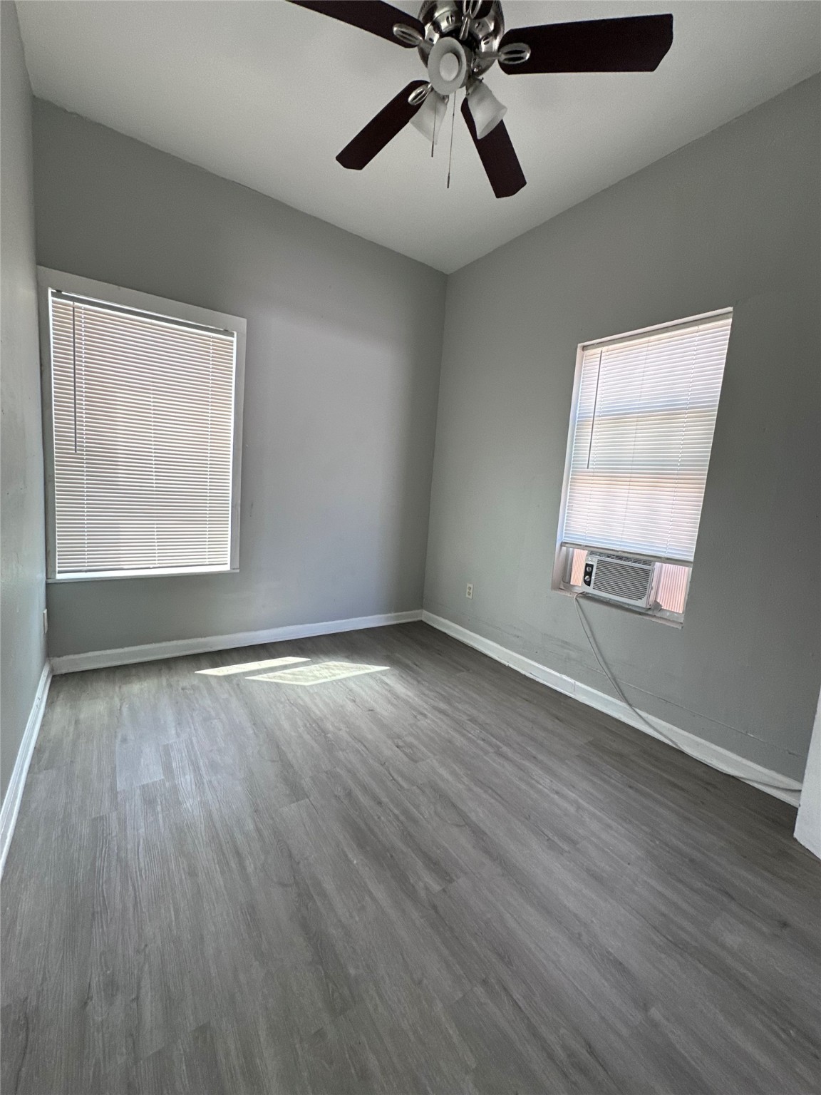 910 37th Street, Unit 3 Galveston, TX 77550 - Photo 9 of 18 wooden floor in an empty room with a window