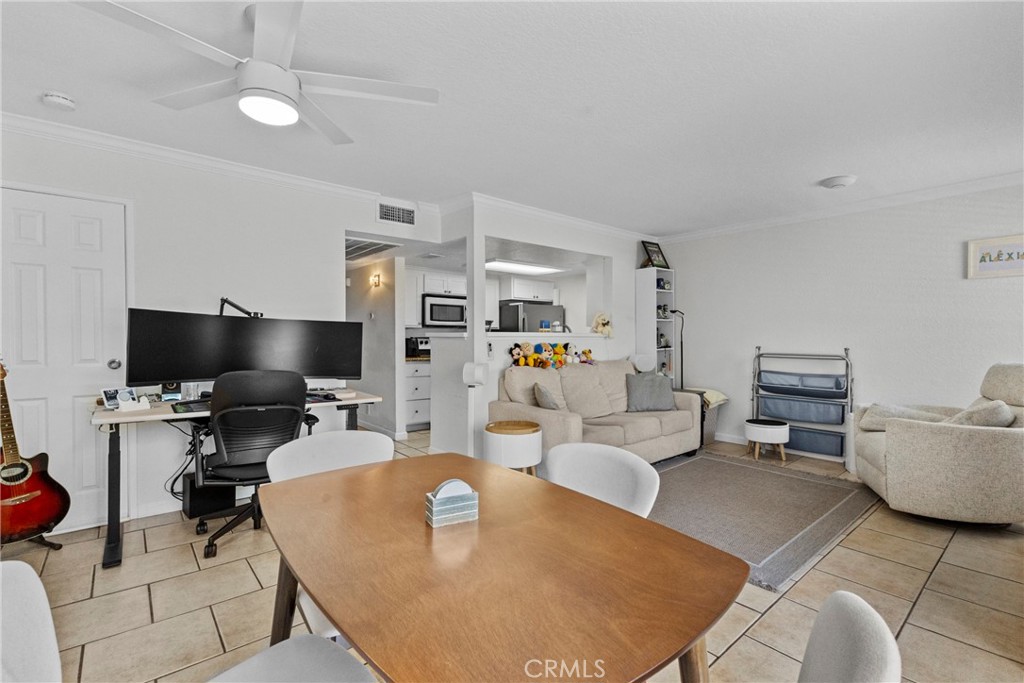 10151 Arrow Route, Unit 6 Rancho Cucamonga, CA 91730 - Photo 7 of 24 a living room with furniture and a flat screen tv