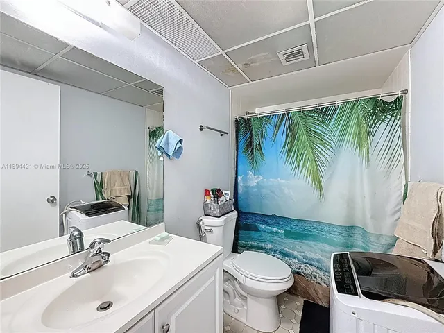 a bathroom with a toilet sink and tub