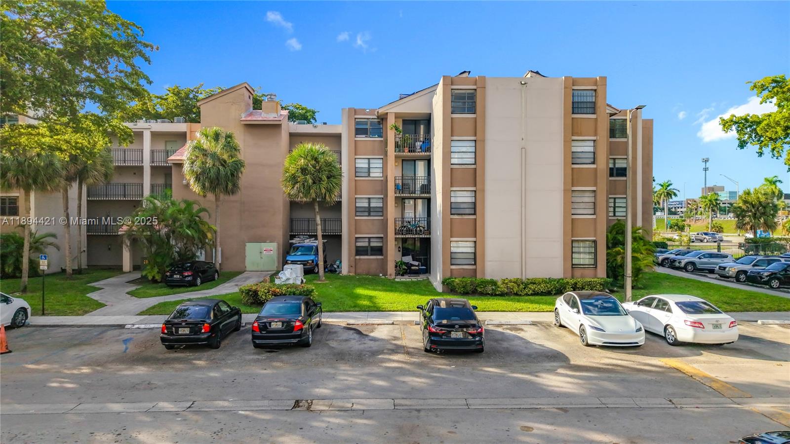 3611 Southwest 117th Avenue, Unit 10207 Miami, FL 33175 - Photo 2 of 35 a view of a cars park in front of a building