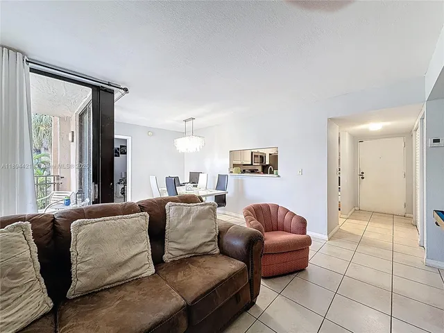 a living room with a couch and a view of kitchen
