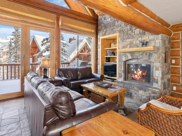 a living room with furniture fireplace and a large window