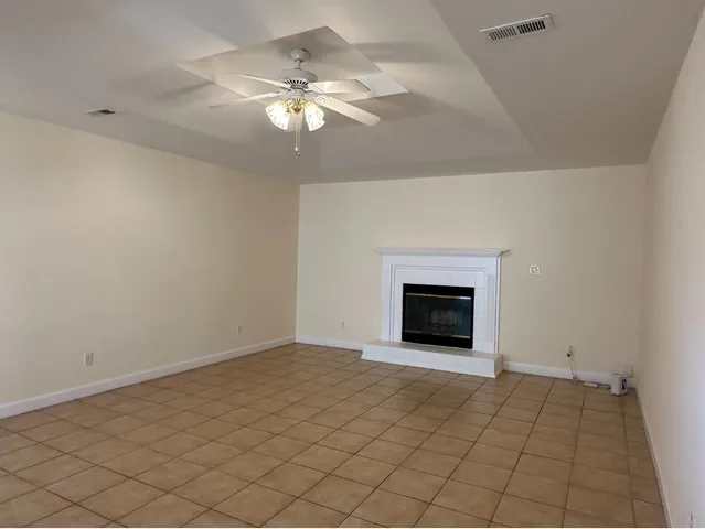 an empty room with a empty space and windows