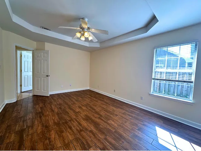 a bathroom with a granite countertop sink a light fixture and a mirror