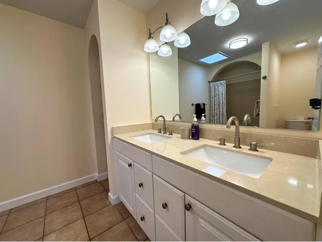 a bathroom with a double vanity sink and a mirror