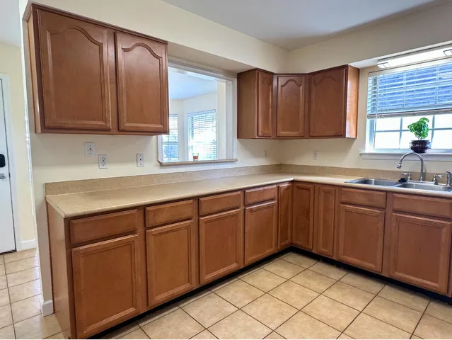a kitchen with stainless steel appliances granite countertop cabinets and window