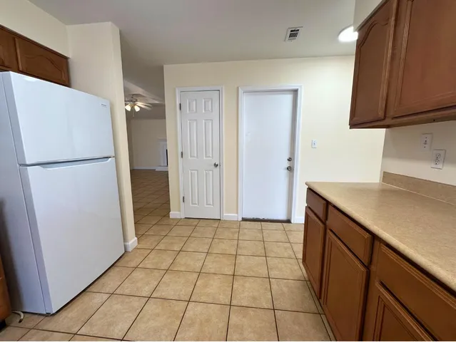 a utility room with cabinets washer and dryer
