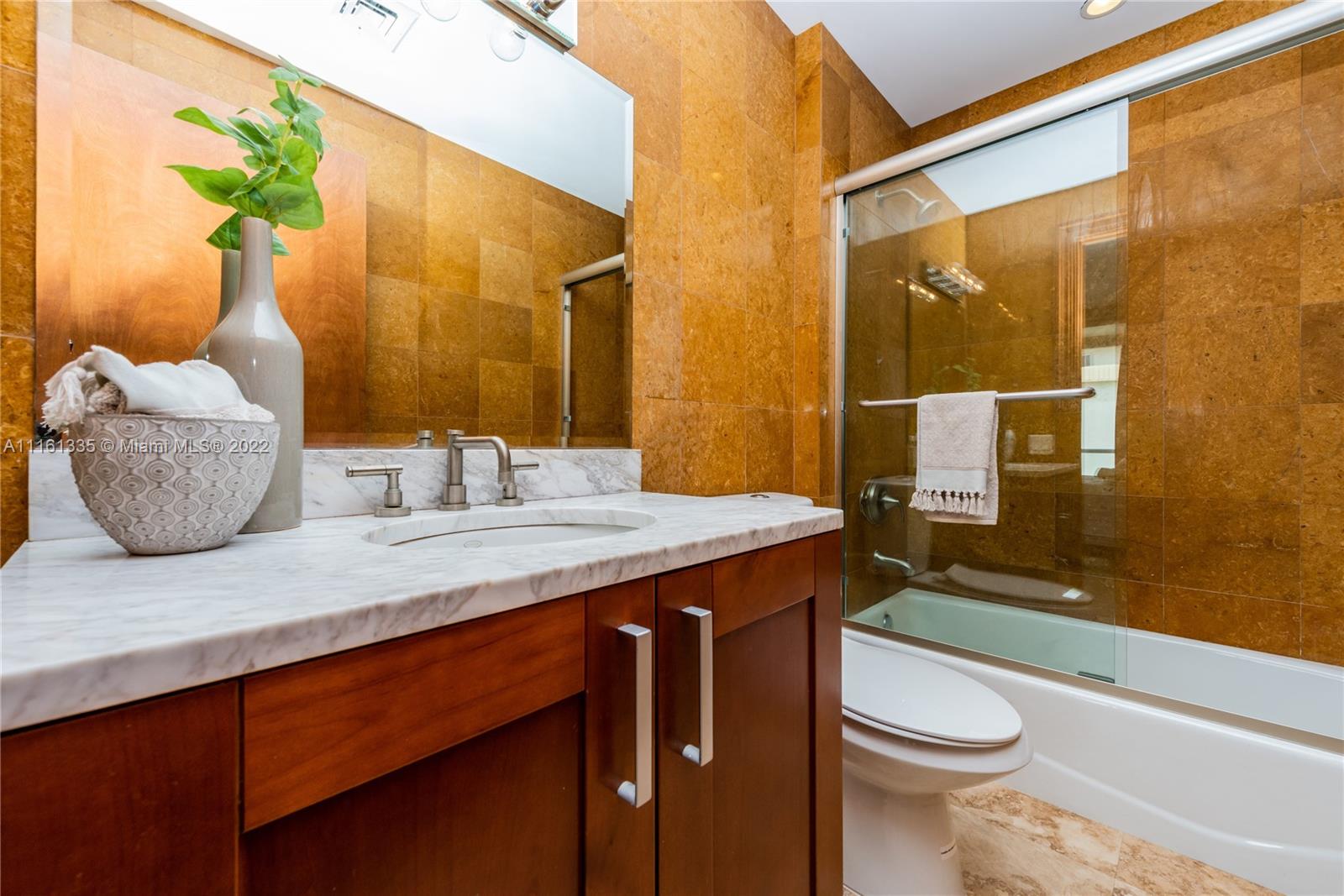 9499 Collins Avenue, Unit PH2 Surfside, FL 33154 - Photo 13 of 38 a bathroom with a granite countertop sink mirror vanity and toilet
