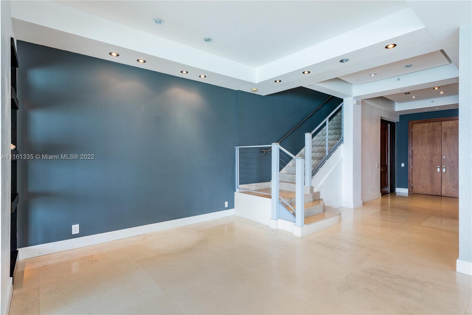 9499 Collins Avenue, Unit PH2 Surfside, FL 33154 - Photo 16 of 38 a view of a livingroom with stairs