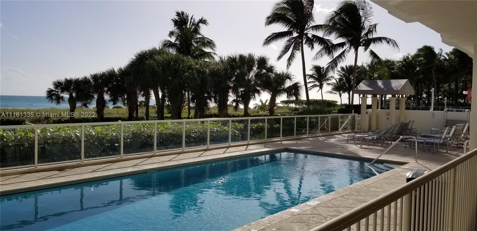9499 Collins Avenue, Unit PH2 Surfside, FL 33154 - Photo 23 of 38 a view of a swimming pool with a lake view