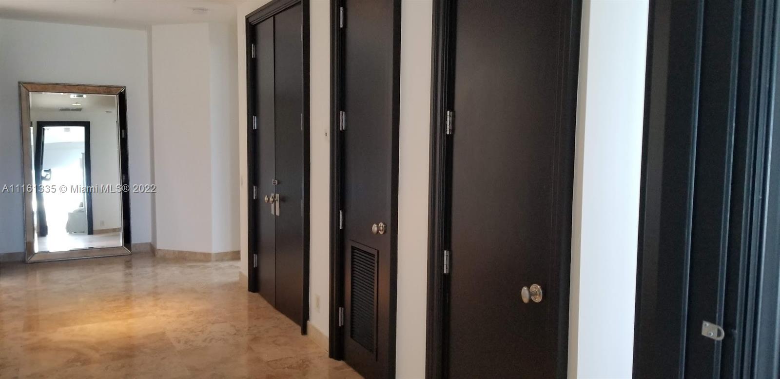 9499 Collins Avenue, Unit PH2 Surfside, FL 33154 - Photo 26 of 38 a view of a hallway with wooden floor