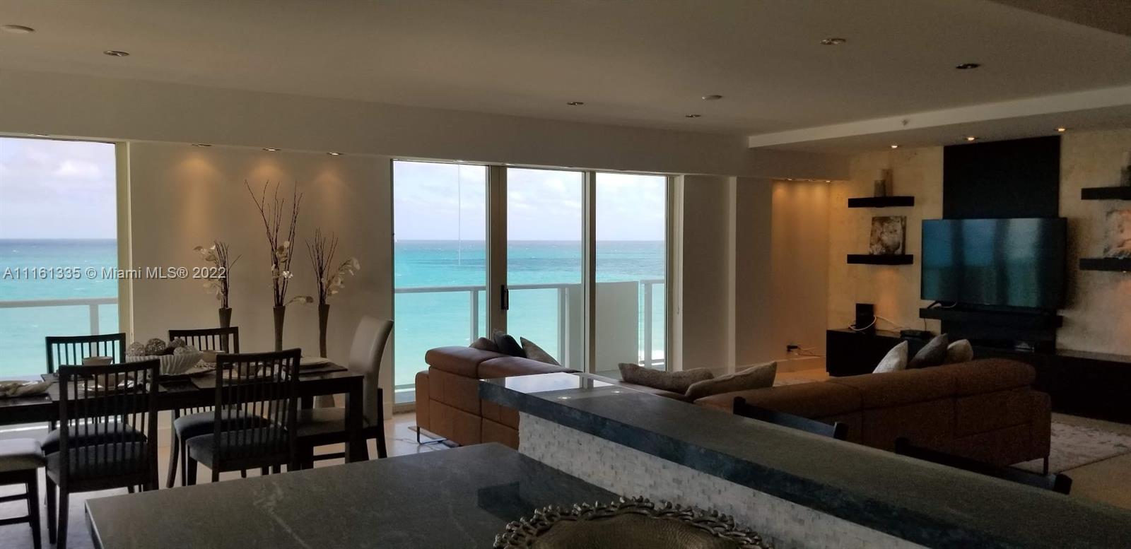 9499 Collins Avenue, Unit PH2 Surfside, FL 33154 - Photo 28 of 38 a living room with furniture and a large window