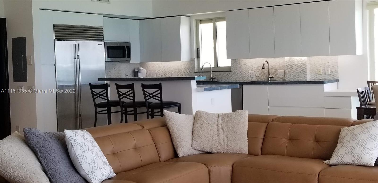 9499 Collins Avenue, Unit PH2 Surfside, FL 33154 - Photo 31 of 38 a living room with furniture and a window