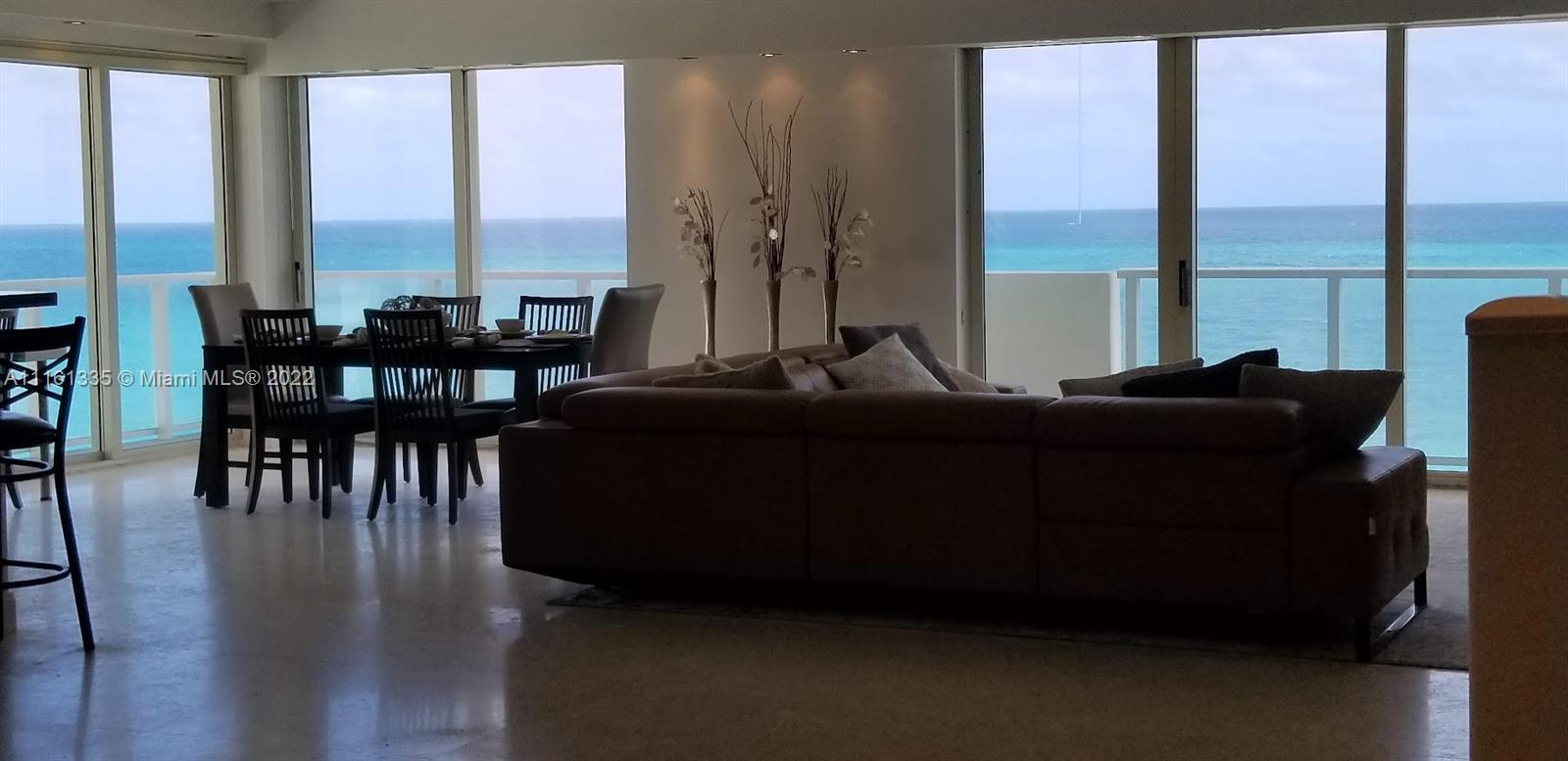 9499 Collins Avenue, Unit PH2 Surfside, FL 33154 - Photo 36 of 38 a living room with furniture and large windows