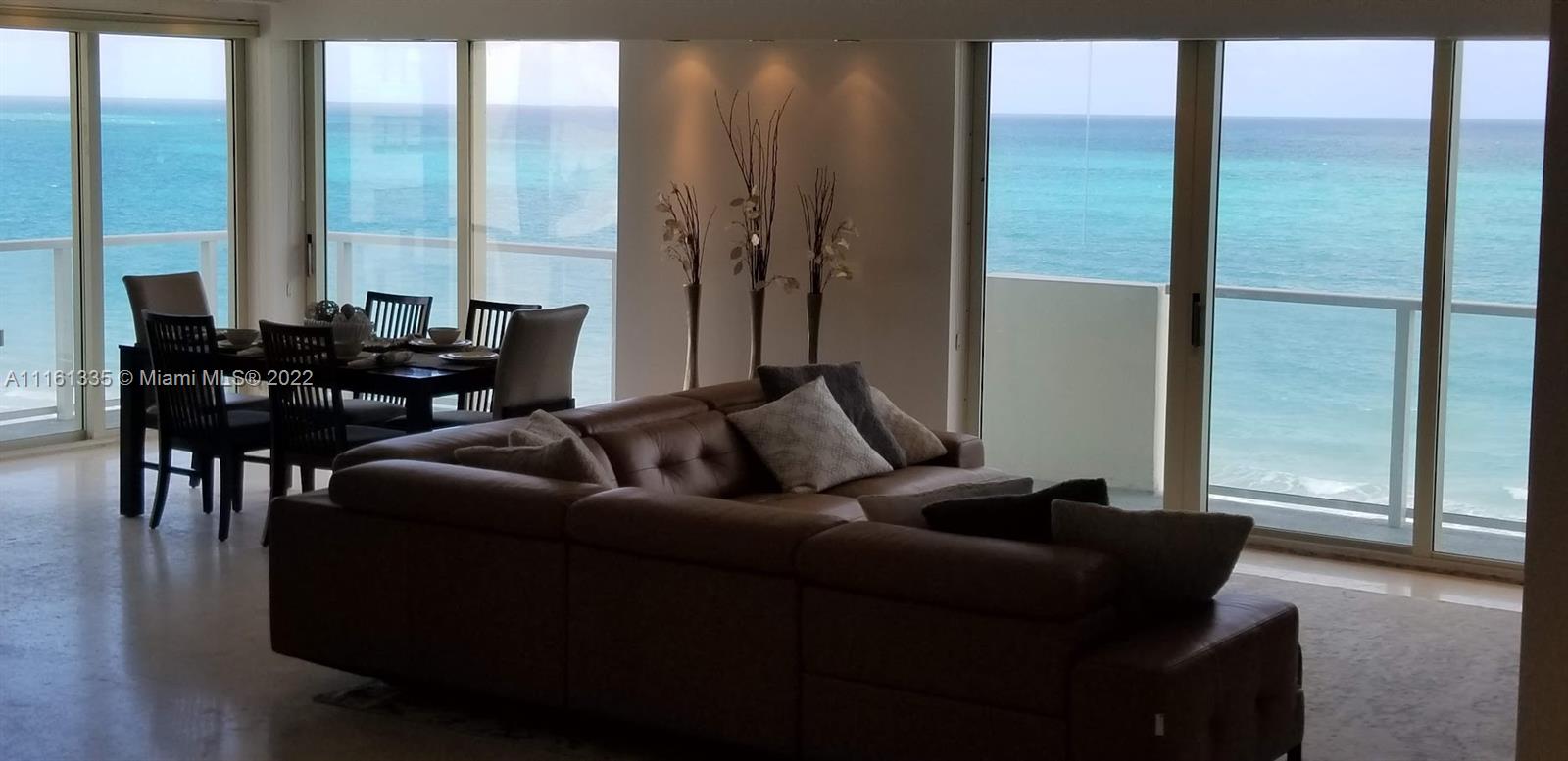 9499 Collins Avenue, Unit PH2 Surfside, FL 33154 - Photo 37 of 38 a living room with furniture and floor to ceiling windows