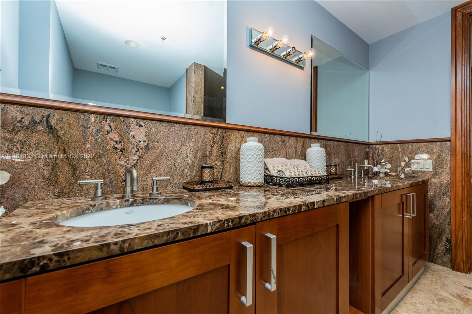 9499 Collins Avenue, Unit PH2 Surfside, FL 33154 - Photo 6 of 38 a bathroom with a granite countertop sink and a mirror