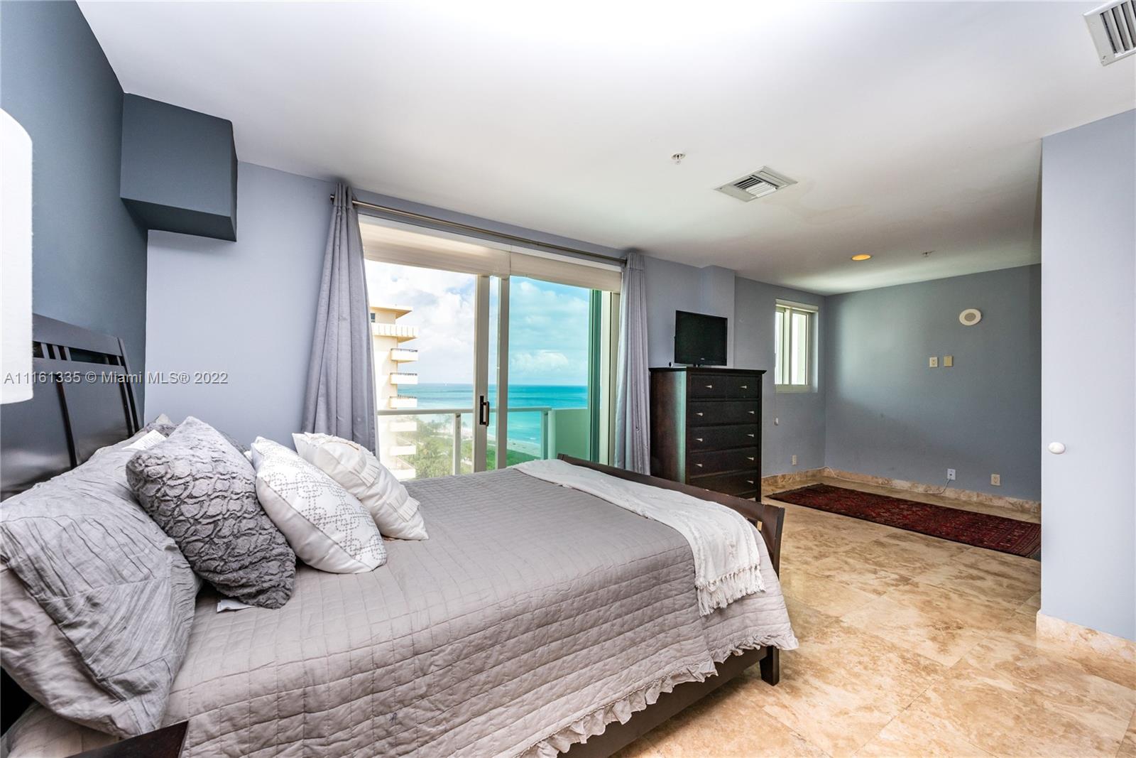 9499 Collins Avenue, Unit PH2 Surfside, FL 33154 - Photo 7 of 38 a bed sitting in a spacious bedroom next to a window