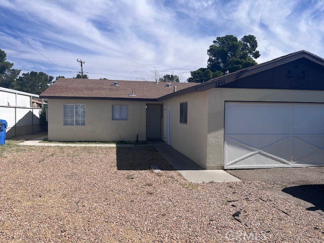 1841 Armory Road Barstow, CA 92311 - Photo 1 of 1 a front view of a house with a yard and garage