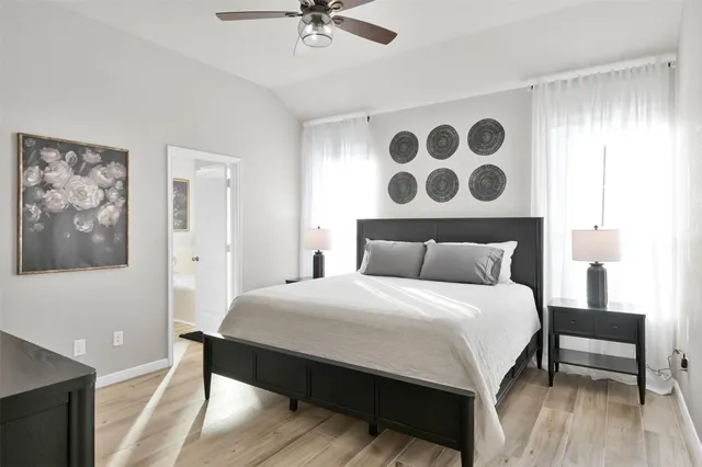 a bedroom with a bed dresser and a flat screen tv