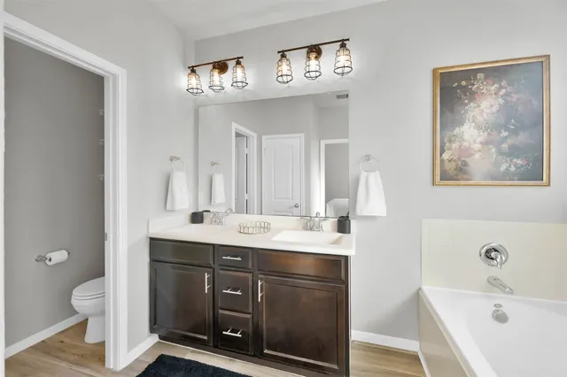 a white bath tub sitting next to a shower