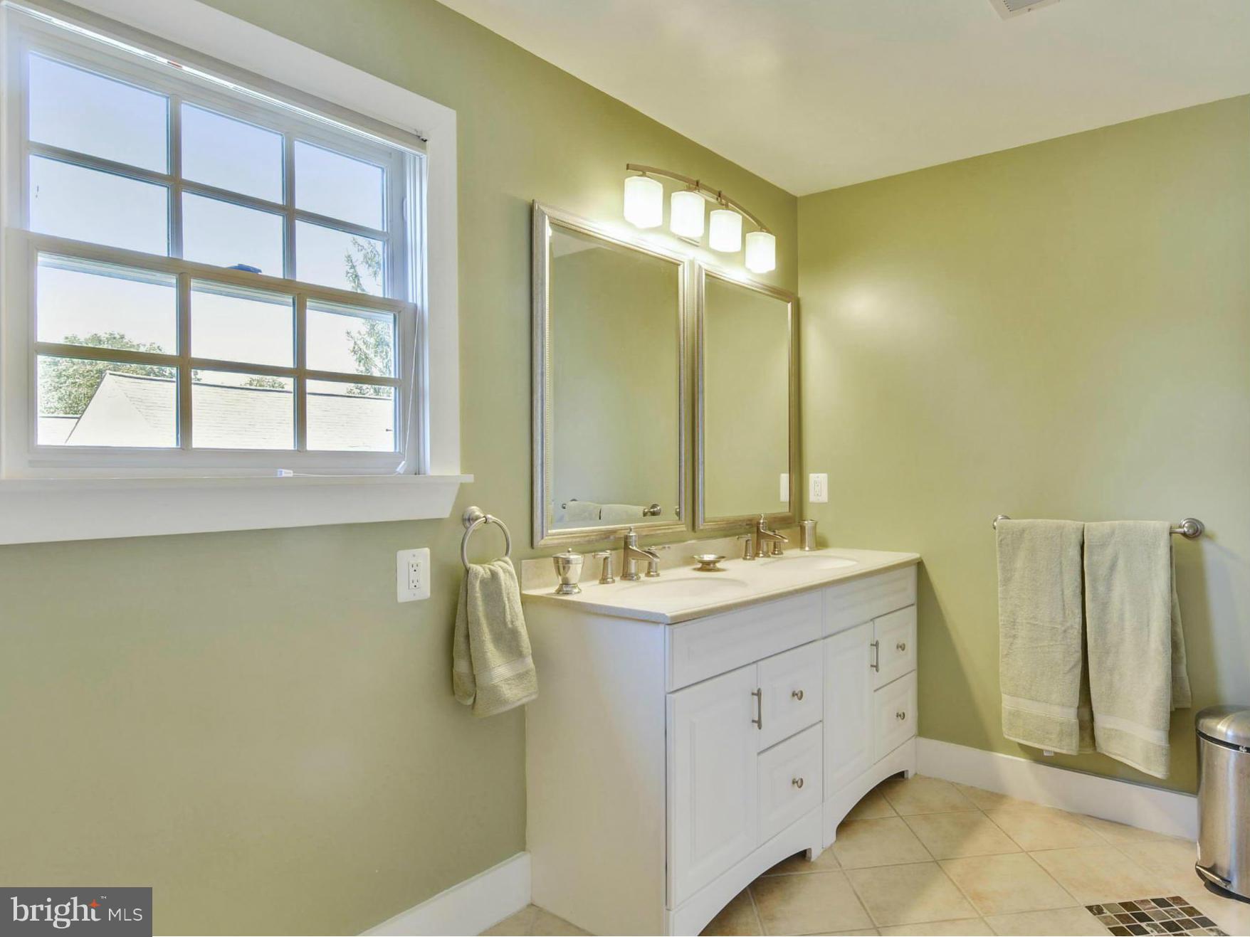 8822 1st Avenue Silver Spring, MD 20910 - Photo 19 of 30 a bathroom with a double vanity sink and a mirror