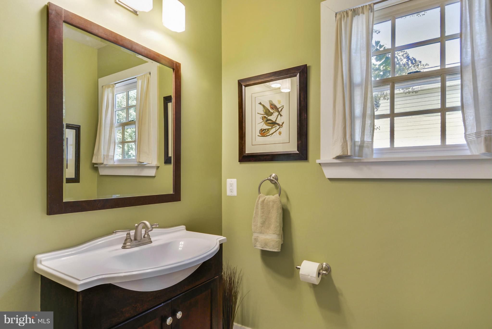 8822 1st Avenue Silver Spring, MD 20910 - Photo 9 of 30 a bathroom with a sink and a mirror