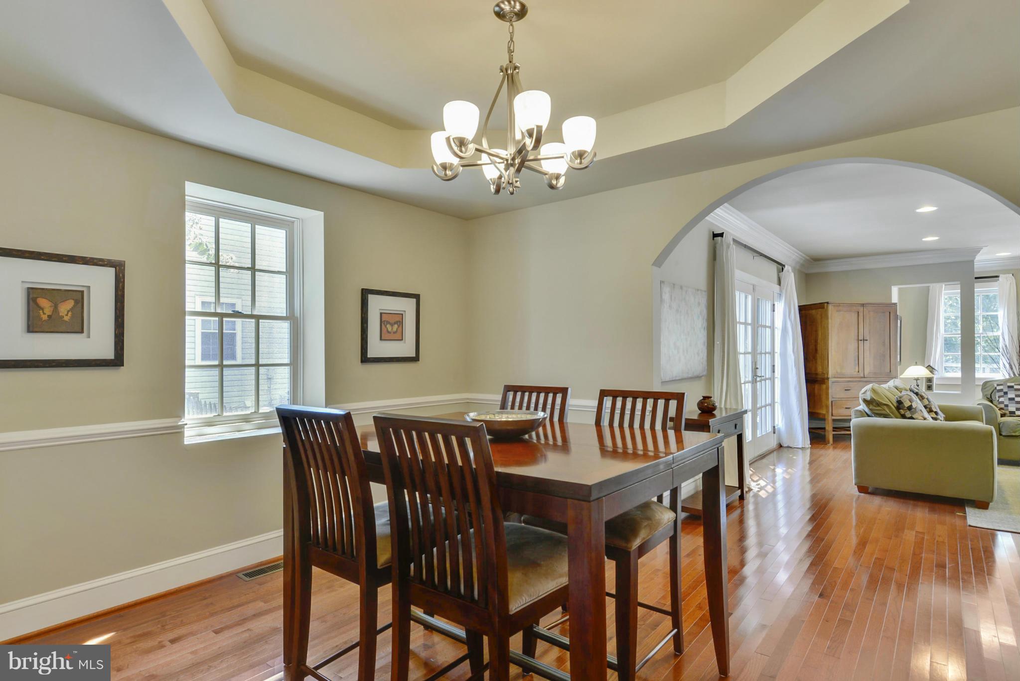 8822 1st Avenue Silver Spring, MD 20910 - Photo 10 of 30 a view of a dining room with furniture wooden floor and chandelier
