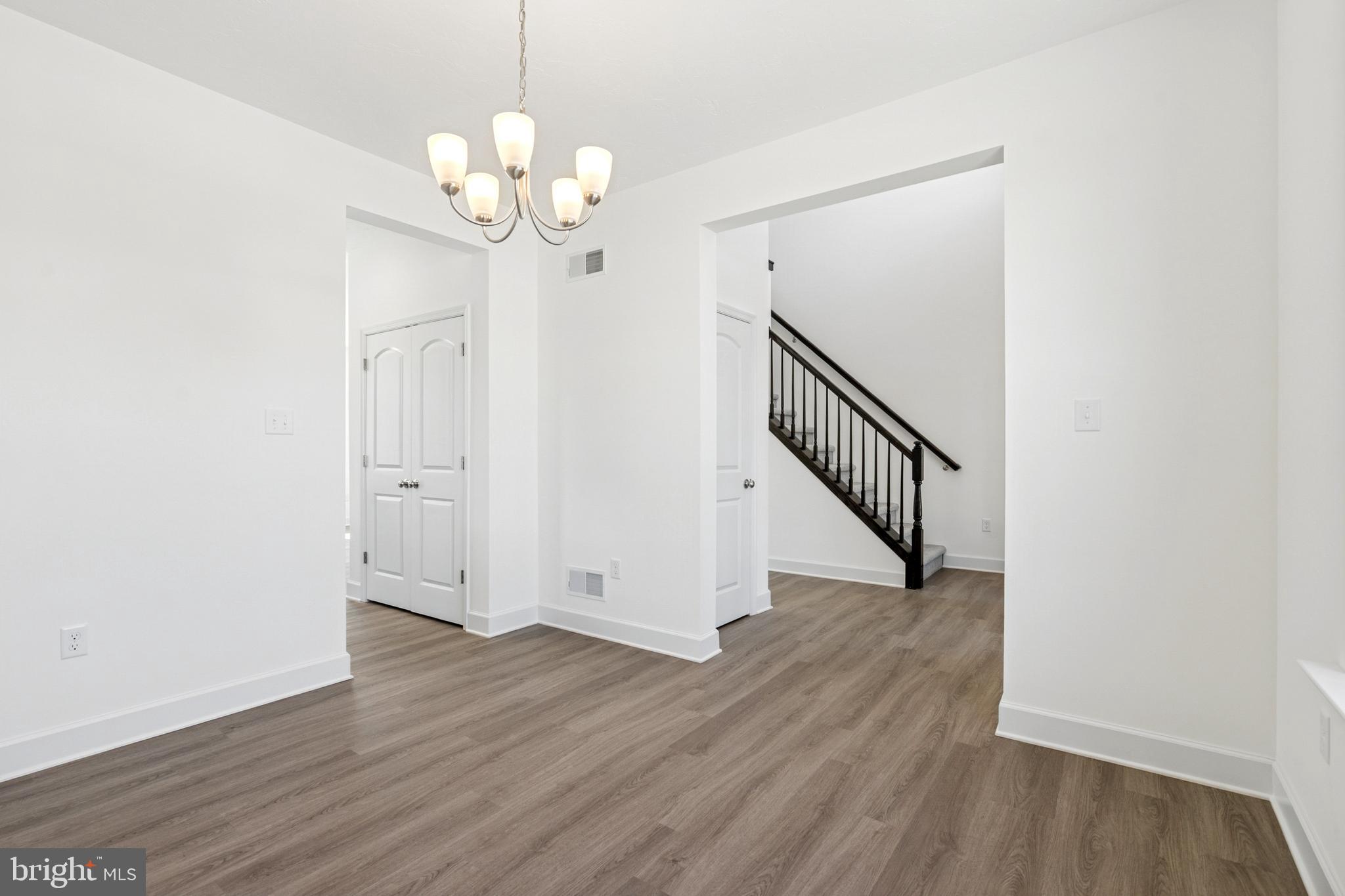 2691 Victorian Drive Dover, PA 17315 - Photo 7 of 18 a view of a hallway with wooden floor and chandelier