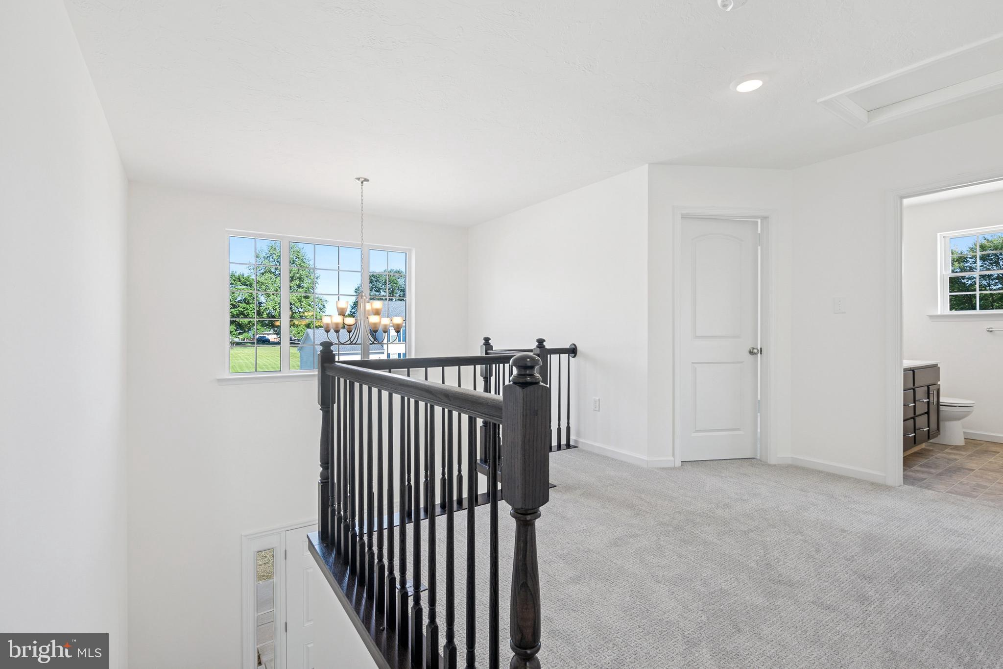 2691 Victorian Drive Dover, PA 17315 - Photo 8 of 18 a view of a hallway with a window and stairs