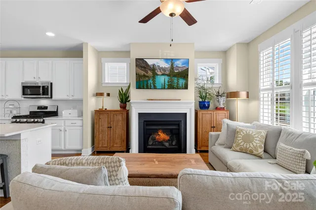 a living room with furniture a fireplace and a flat screen tv