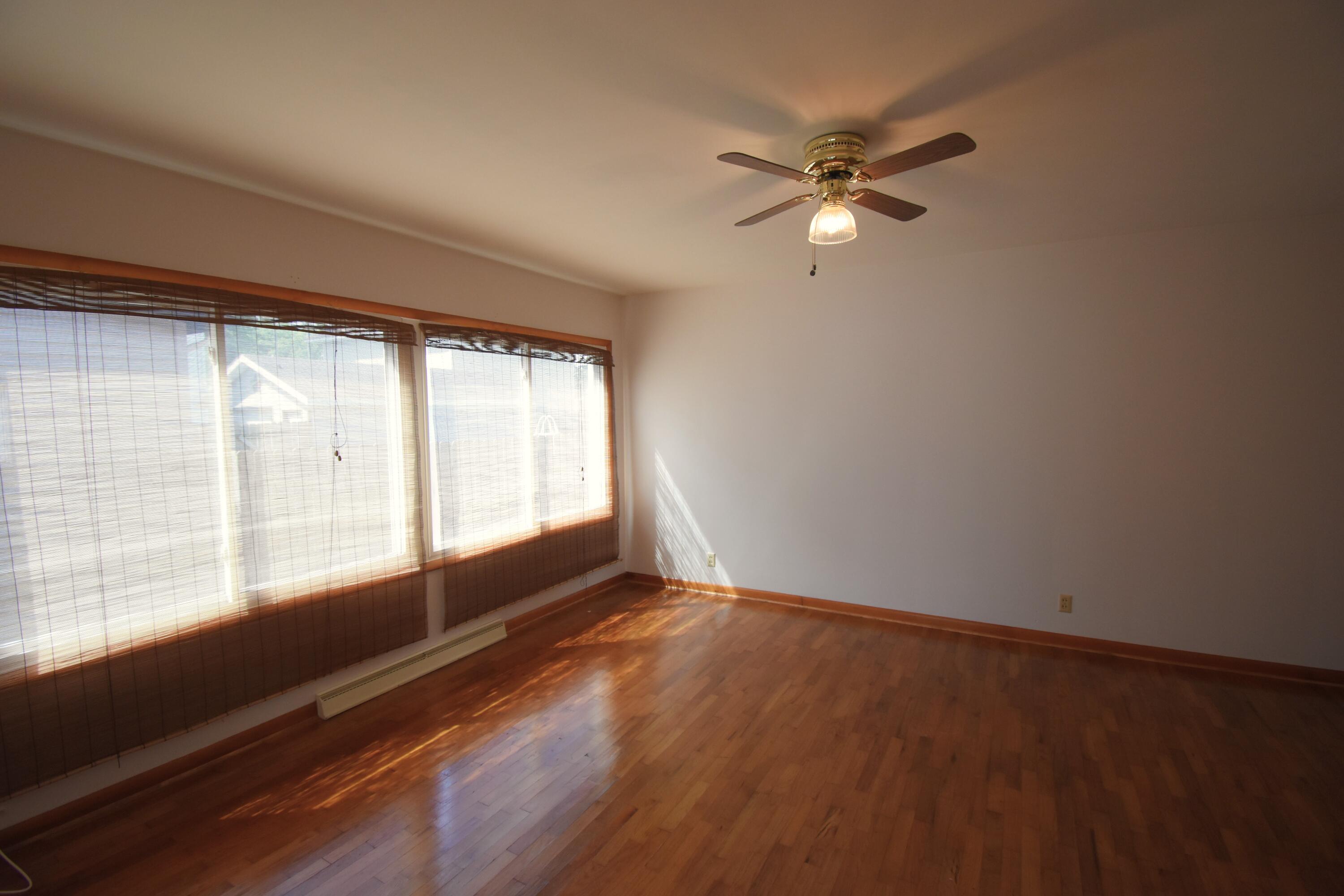 328 South Weston Street Rensselaer, IN 47978 - Photo 21 of 39 a view of empty room with wooden floor and fan