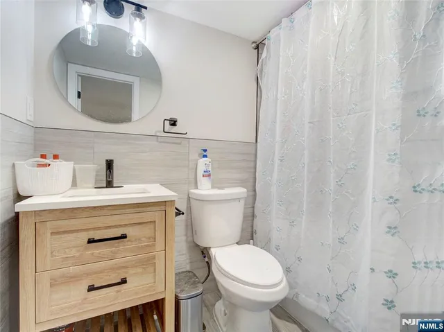 a bathroom with a sink a toilet and a mirror