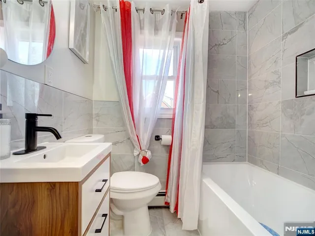 a bathroom with a sink a toilet and a bathtub