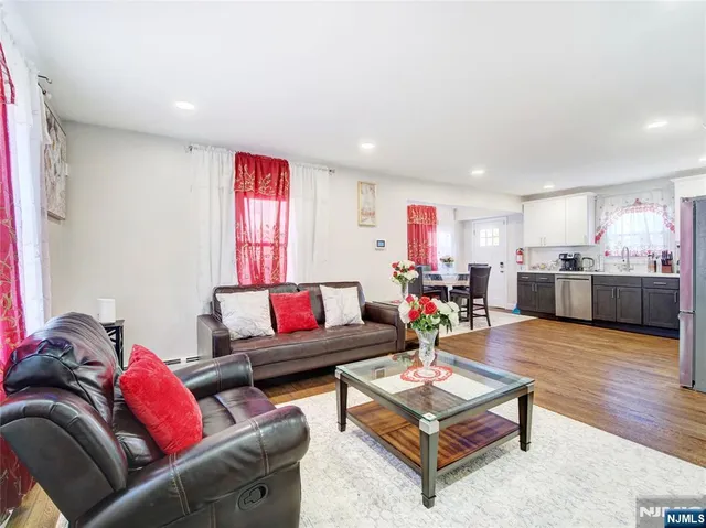 a living room with furniture and kitchen view
