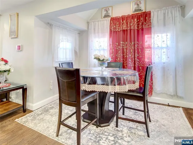 a view of a dining room with furniture and window