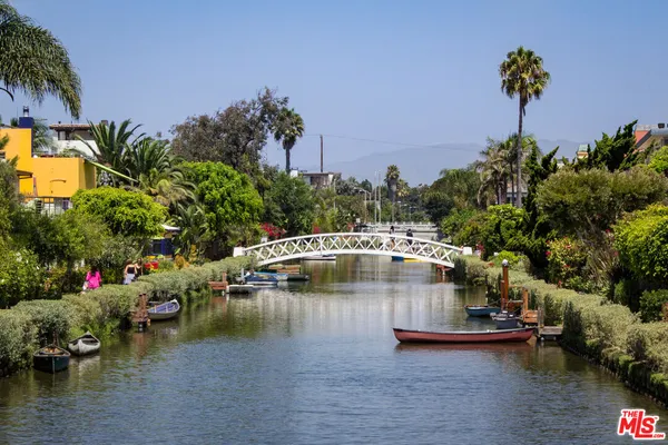 a view of a swimming pool with a yard and a fountain