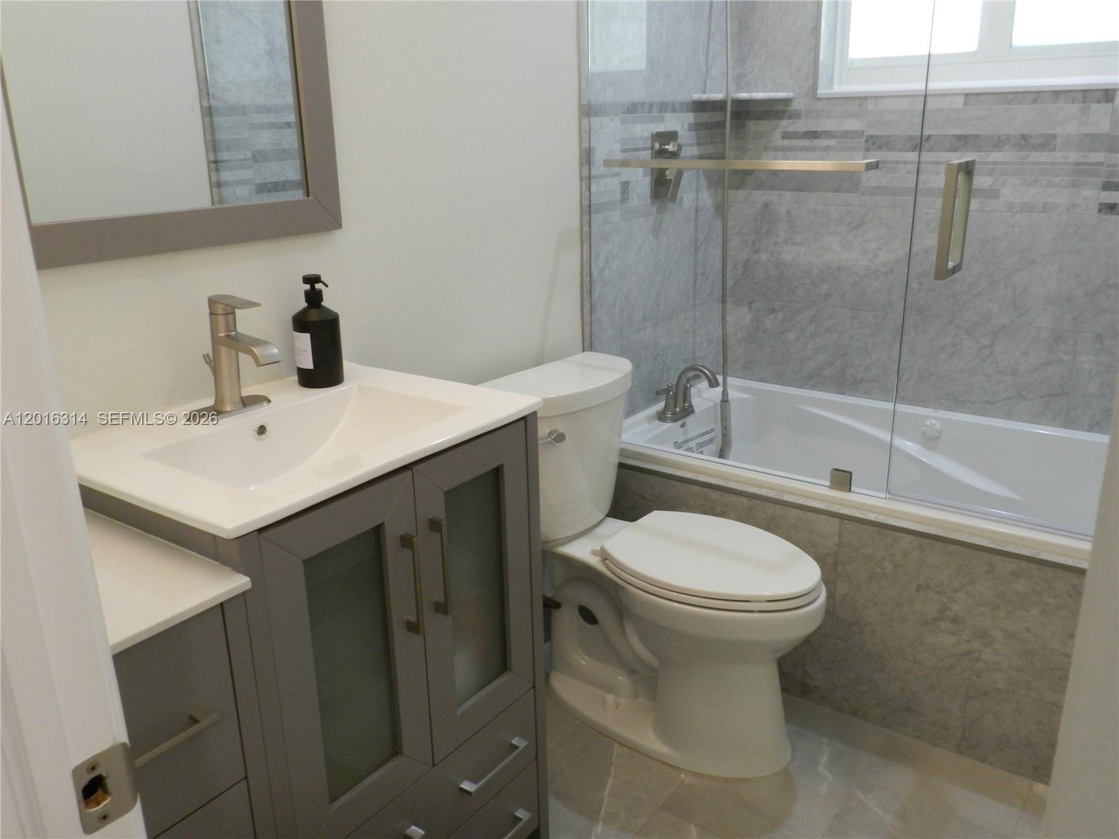 305 Northwest 42nd Street Boca Raton, FL 33431 - Photo 15 of 31 a bathroom with a sink toilet and shower