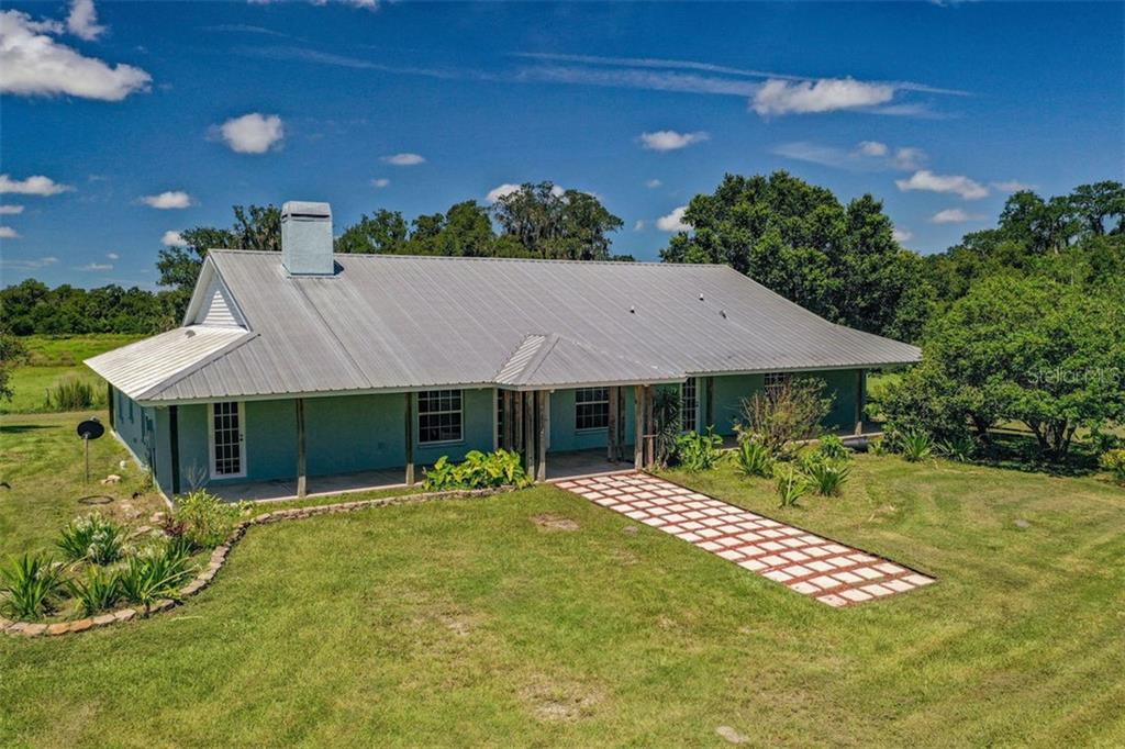 14980 Leeann Road Sarasota, FL 34240 - Photo 1 of 1 Dignified and spacious Cracker-style home on a 10-acre mini-estate features a high pitch metal roof and full length front and rear porches.