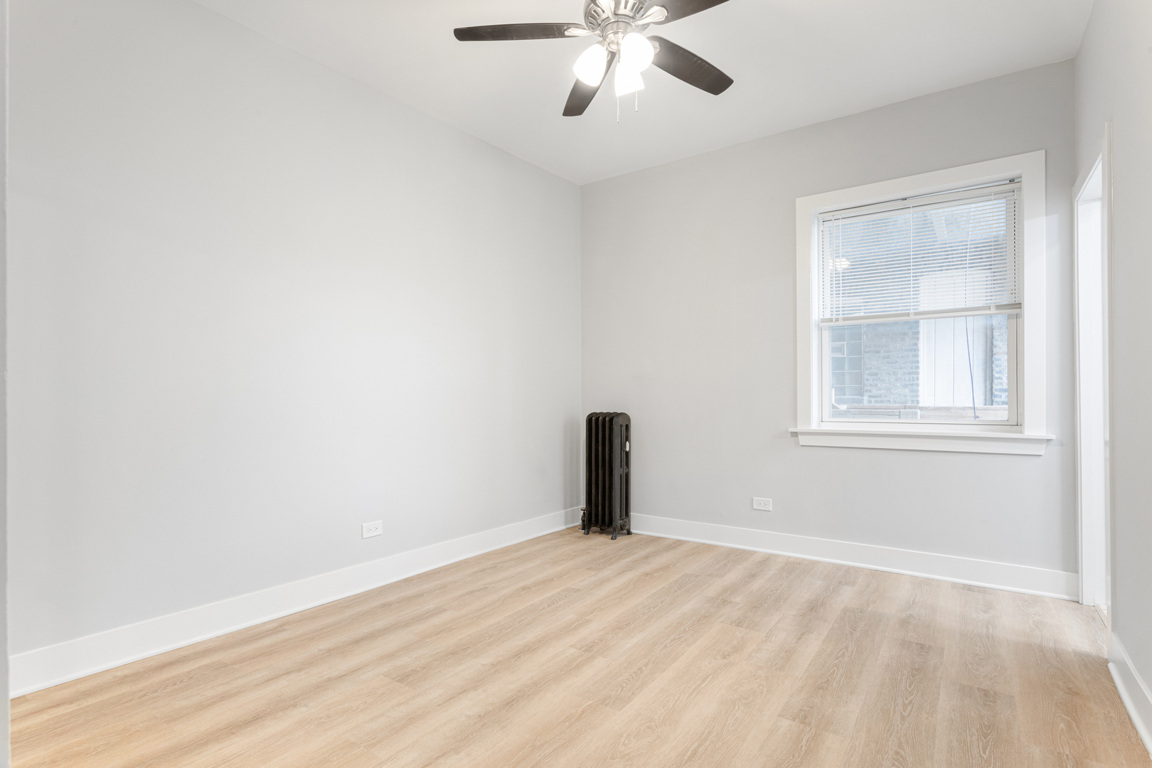 7600 North Sheridan Road, Unit 208 Chicago, IL 60626 - Photo 7 of 10 a view of a room with a empty space and chandelier fan