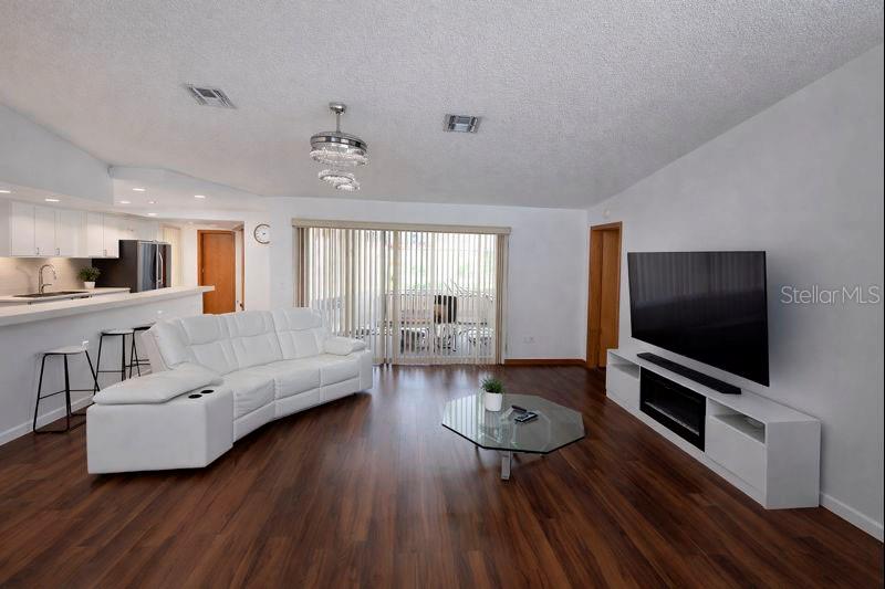 2202 Perry Avenue Spring Hill, FL 34609 - Photo 4 of 11 a living room with furniture and a flat screen tv