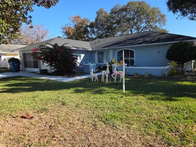 a backyard of a house with yard fire pit and furniture
