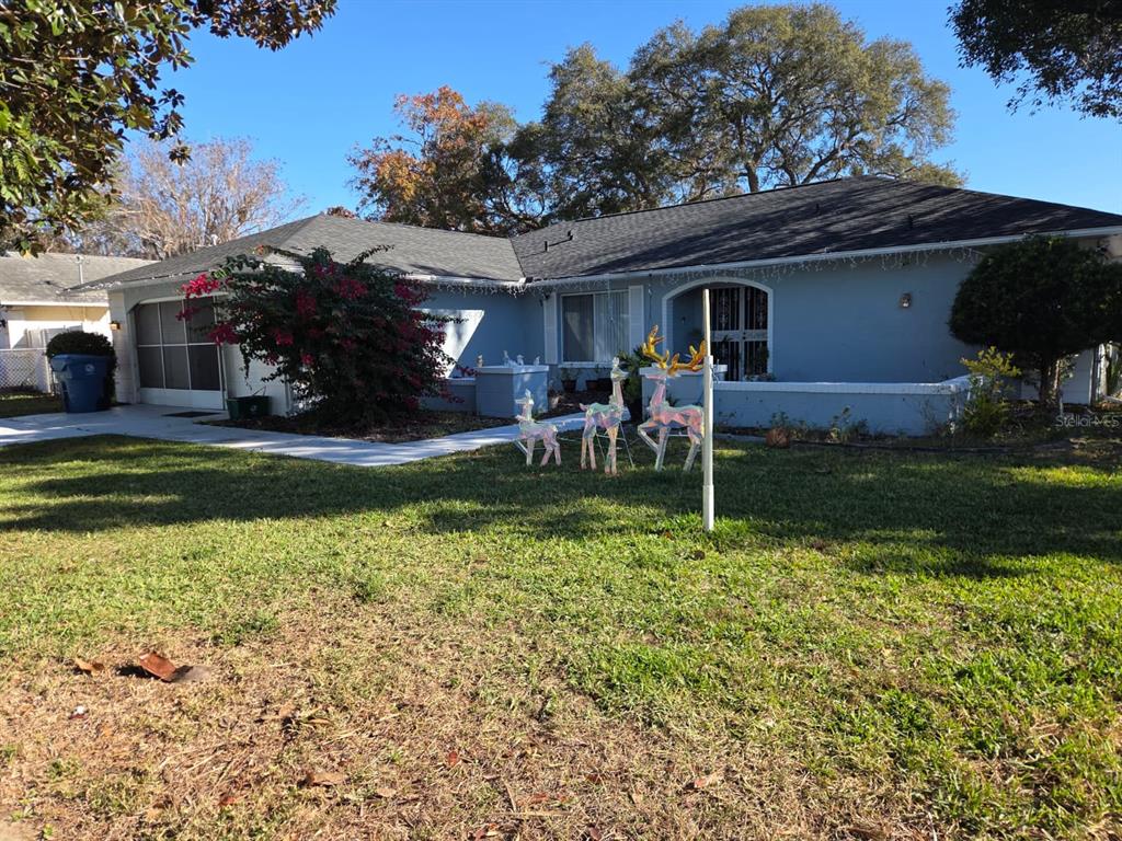 2202 Perry Avenue Spring Hill, FL 34609 - Photo 7 of 11 a backyard of a house with yard fire pit and furniture
