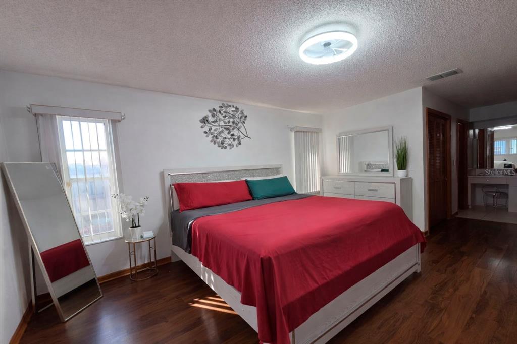 2202 Perry Avenue Spring Hill, FL 34609 - Photo 10 of 11 a bedroom with a bed and a chair